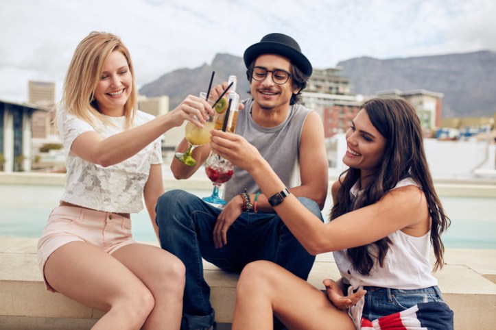 Happy young friends having cocktail party